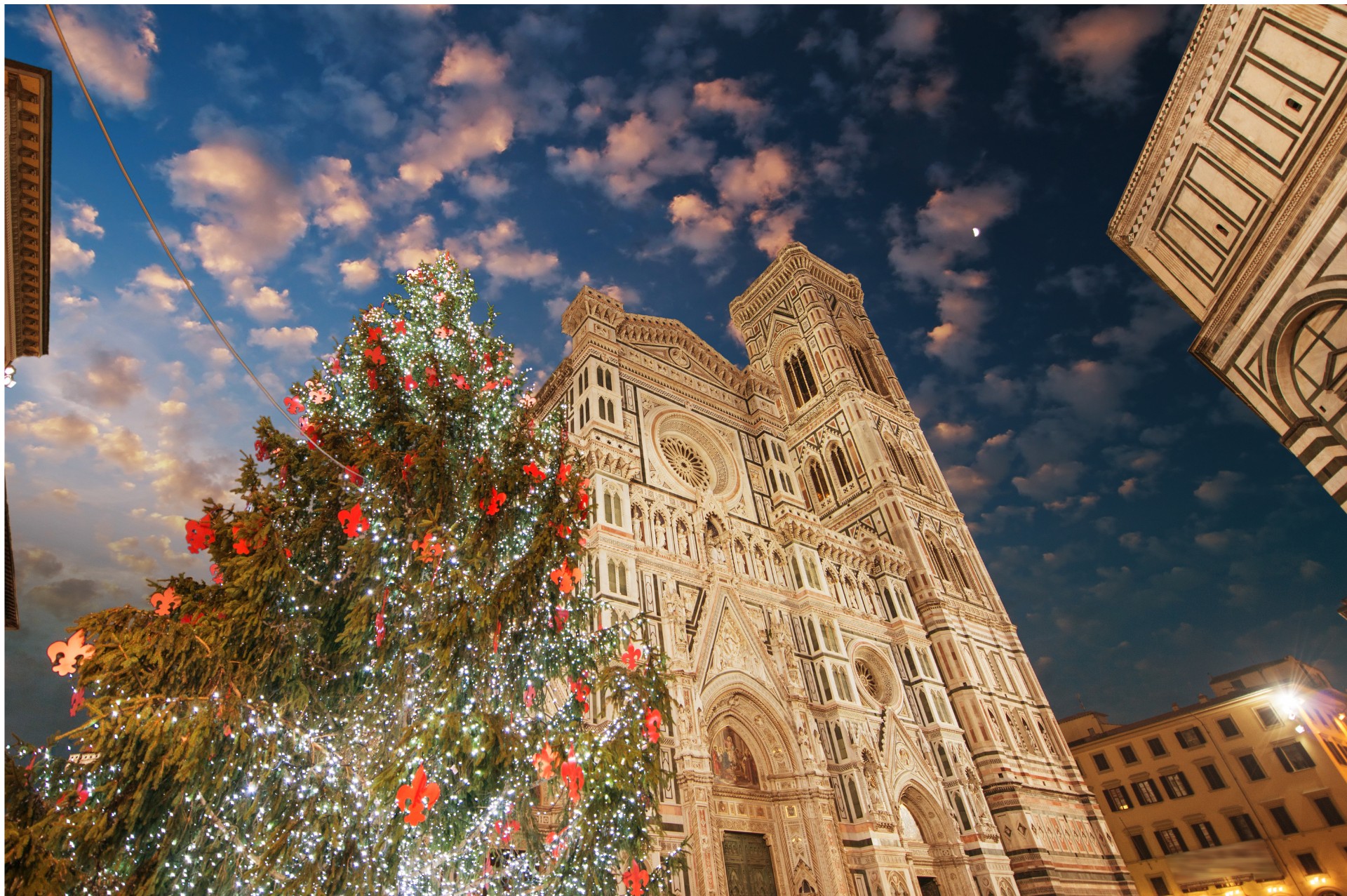 Florence Cathedral with a Christmas tree decorated with red ornaments at sunset