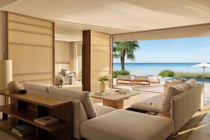 Luxury beachfront residence with open-plan living room, private pool and ocean views.